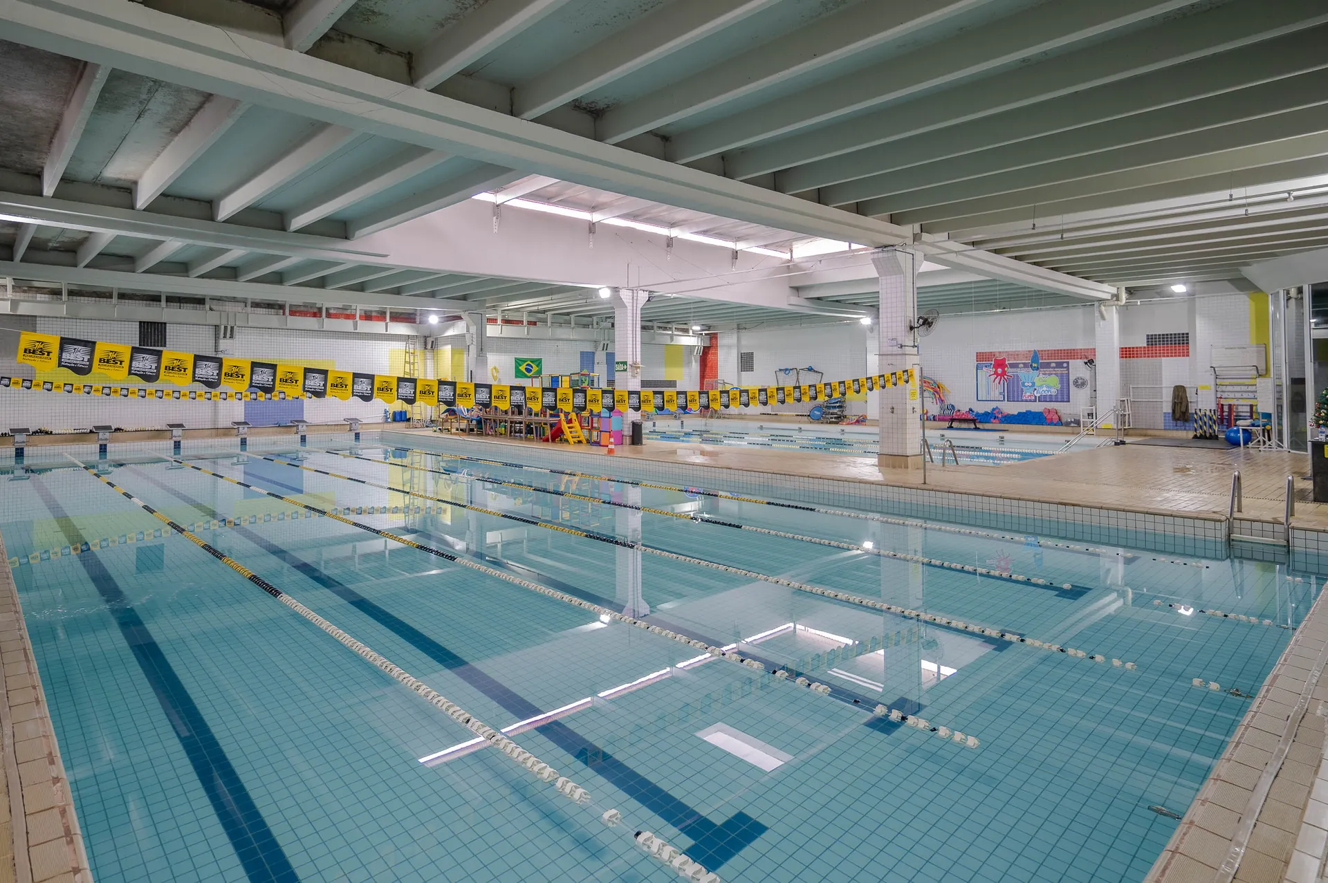 Piscina semiolímpica com raias montadas e bandeirinhas amarelas